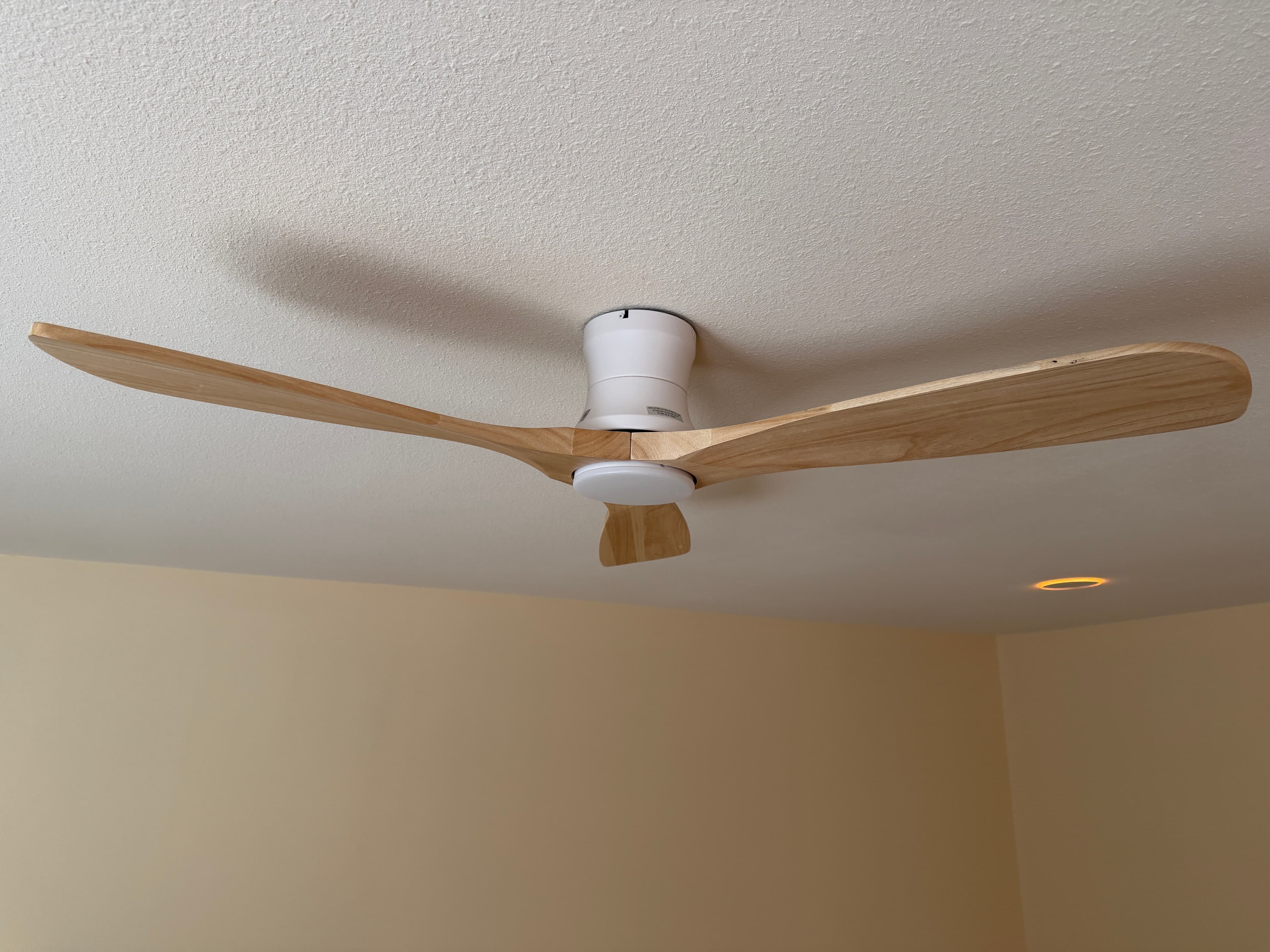 Modern ceiling fan replacements installed throughout a Reno home, including wood-finish fans and a white kids bedroom fan