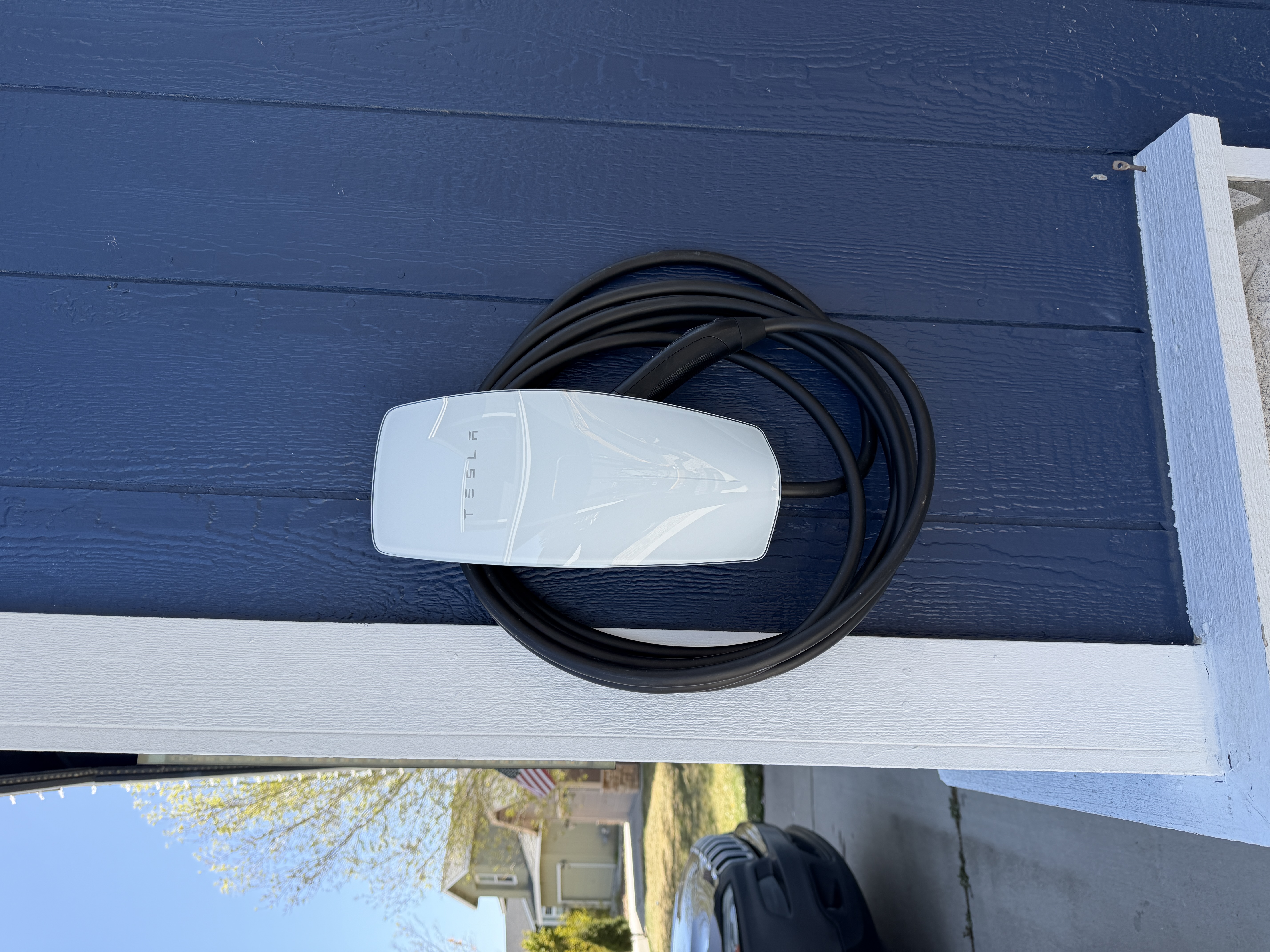 Outdoor Tesla Wall Connector installed on the exterior wall of a Reno garage