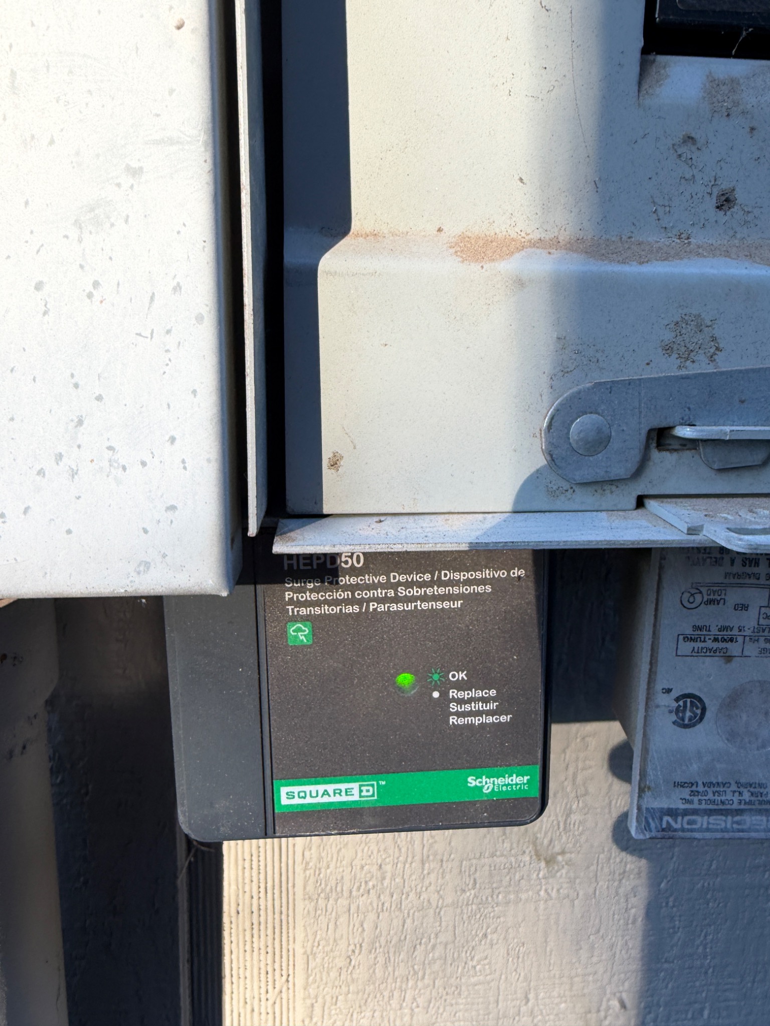 Installed whole-home surge protective device at a Sparks home with its green OK status indicator illuminated