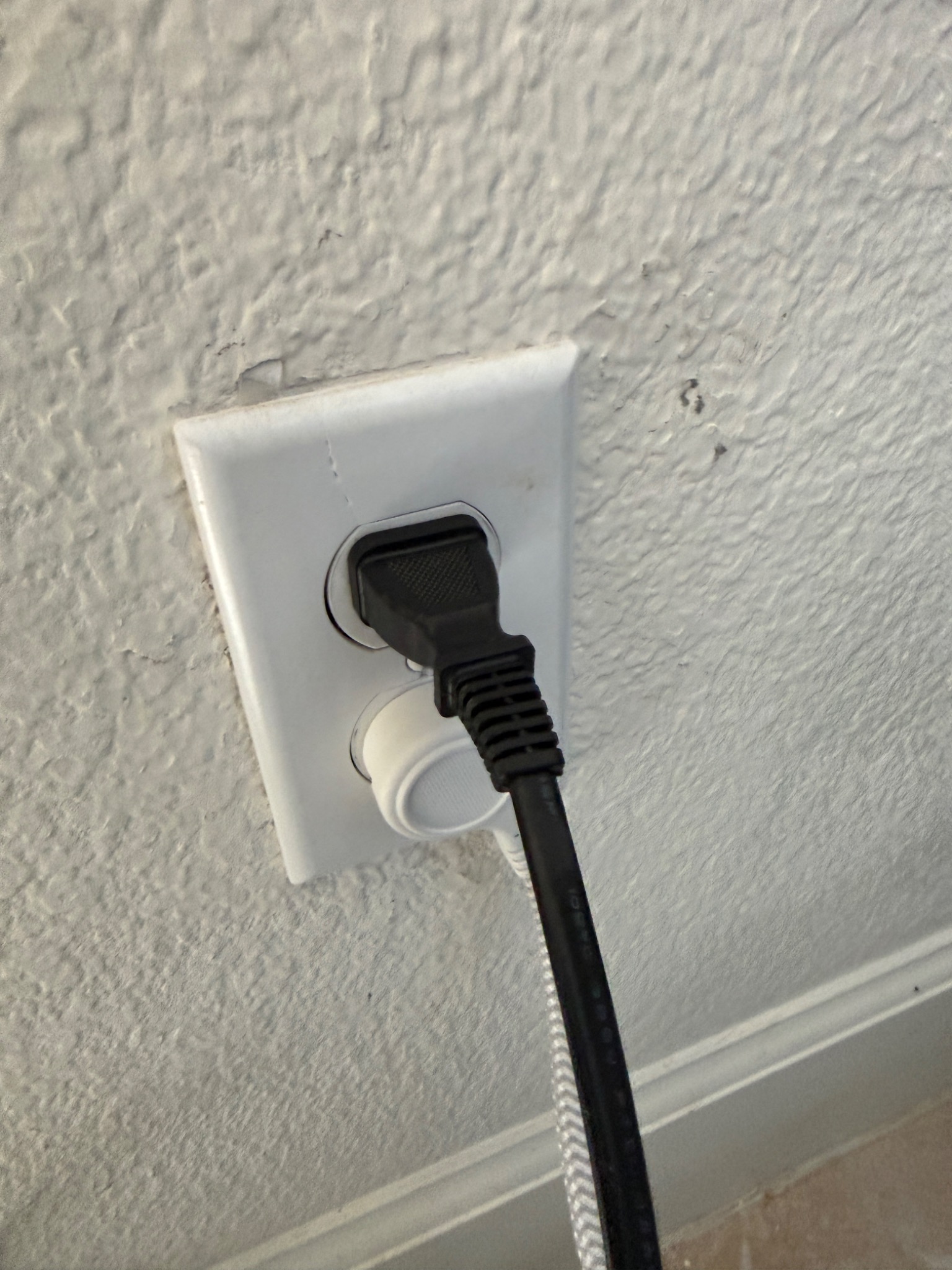 Completed living room outlet replacement in South Reno with cords plugged into the new receptacle